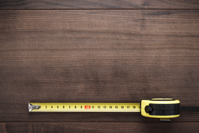 measuring tape on wood background