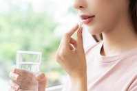 woman taking supplement